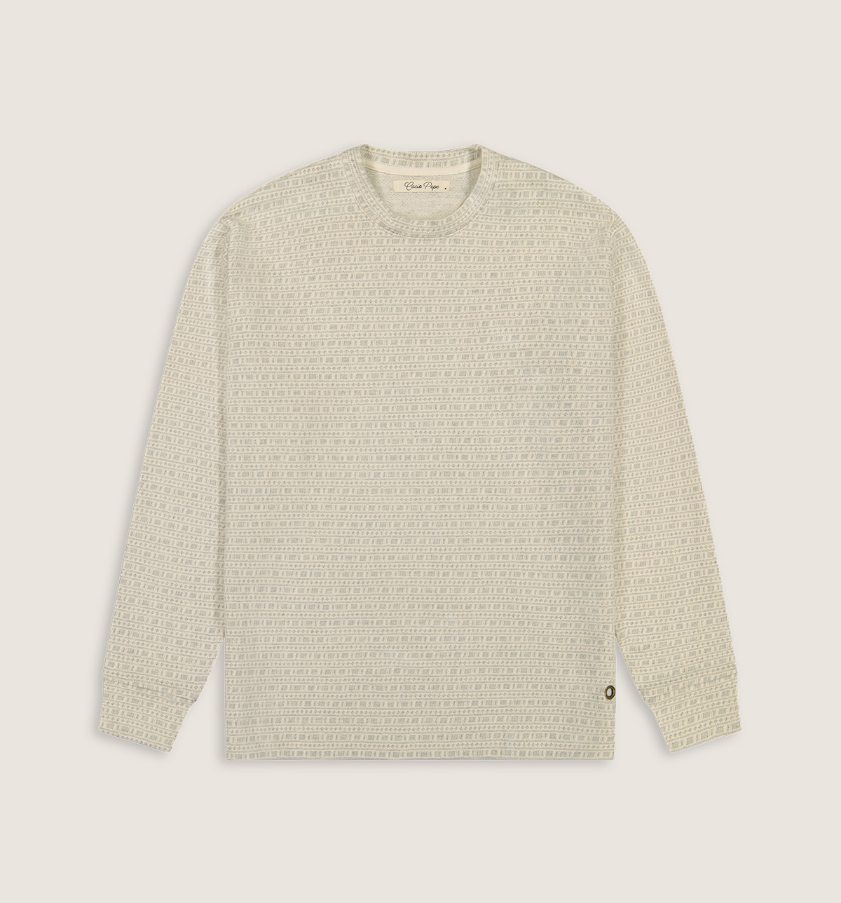 A long-sleeve crewneck knit sweater in a textured cream and light beige pattern, shown flat against a solid light beige background.
