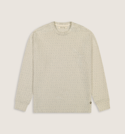 A long-sleeve crewneck knit sweater in a textured cream and light beige pattern, shown flat against a solid light beige background.